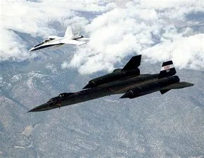 SR-71 Blackbird from above left front with escort in flight